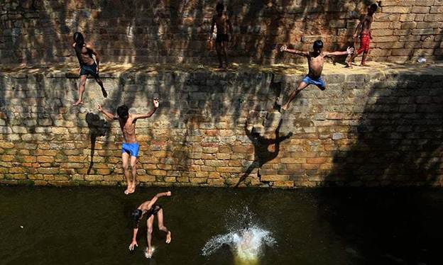 Description: In this representative photo, an Indian youth jumps into the water at the Gandak ki Baoli, 'a well with steps' which was constructed during the rule of Emperor Iltutmish, in New Delhi. &mdash; AFP/File